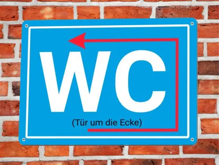 Wegweiser WC um die Ecke Bild